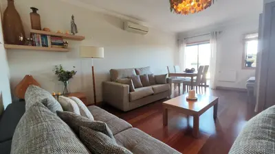 a living room with a couch and a table at Albufeira Oasis Retreat in Albufeira