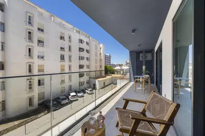 an apartment balcony with a view of a building at Terracos de Quarteira II Purple by Real Properties in Quarteira