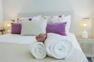 a towel animal made out of towels on a bed at Terracos de Quarteira II Purple by Real Properties in Quarteira