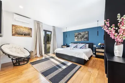 a bedroom with a bed and a blue wall at Casa Chameleon in Almancil