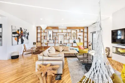 a living room with a hammock in the middle of the room at Casa Chameleon in Almancil