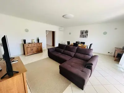 a living room with a couch and a flat screen tv at Ferreiras Villa in Albufeira