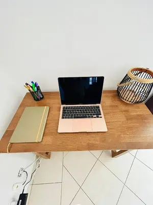a laptop computer sitting on top of a wooden desk at Ferreiras Villa in Albufeira