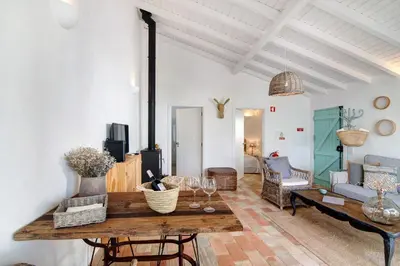 a living room with a table and a couch at Casa de Benafim 1 in Benafim