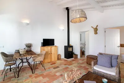 a living room with a table and chairs at Casa de Benafim 1 in Benafim