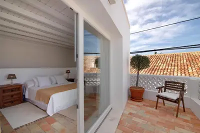 a bedroom with a bed and a sliding glass door at Casa de Benafim 51 in Benafim