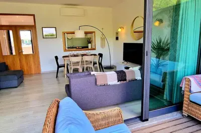 a living room with a couch and a table at Spacious Residence Golf apartment - Vilamoura in Quarteira