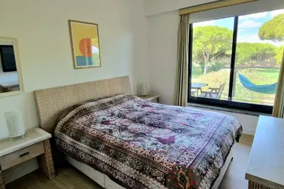 a bedroom with a bed and a large window at Spacious Residence Golf apartment - Vilamoura in Quarteira