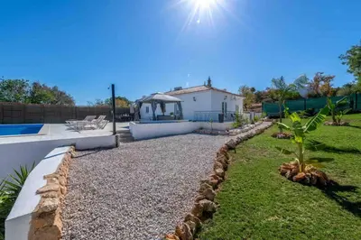 a backyard with a swimming pool and a house at Casa Emella Luxury Villa Albufeira in Albufeira