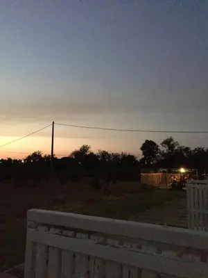 a sunset in a field with a white fence at Solar da Cotovia in Albufeira