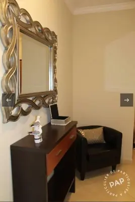a mirror on a wall next to a dresser and a chair at Casa Mar à Vista in Cavacos