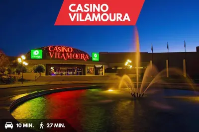 a gas station with a fountain in front of it at night at Sea-Front 1' Min! - Apartment with AC & WiFi in Quarteira