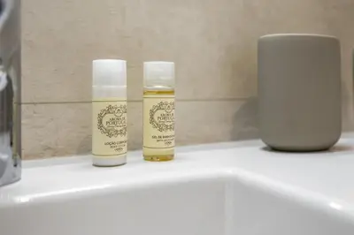 two bottles of essential oils sitting on a bathroom sink at Terracos de Quarteira II Yellow by Real Properties in Quarteira