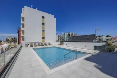 a swimming pool on the roof of a building at Terracos de Quarteira II Yellow by Real Properties in Quarteira