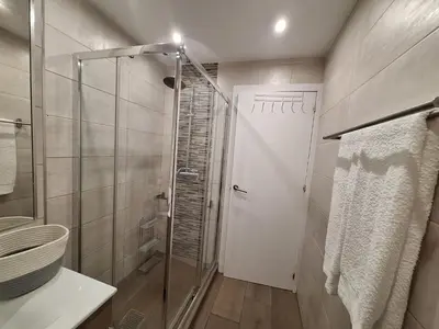 a bathroom with a shower and a glass door at Cool living Quarteira, 2 bedroom with ocean view in Quarteira