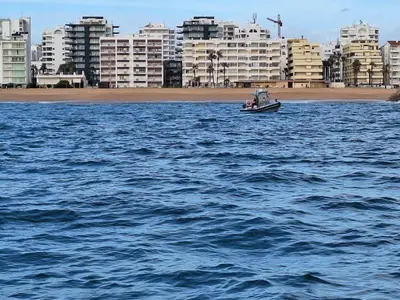 a small boat in the middle of a body of water at Cool living Quarteira, 2 bedroom with ocean view in Quarteira