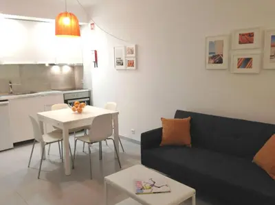 a living room with a couch and a table at Casa Vila Magna T1 in Albufeira