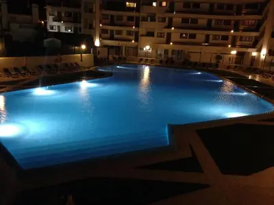 a large swimming pool in a building at night at CASA Vila Magna T0 in Albufeira
