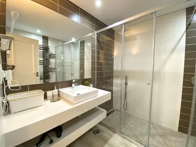 a bathroom with a sink and a glass shower at Albufeira Balaia Golf Vilage 3 With Pool by Homing in Albufeira