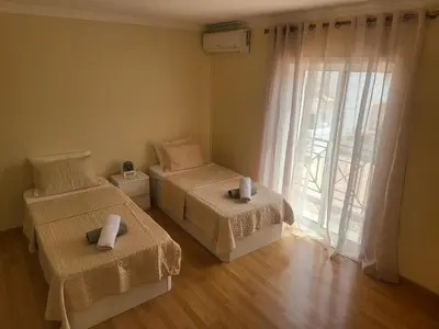 a bedroom with two beds and a large window at Flor do Campo in Albufeira