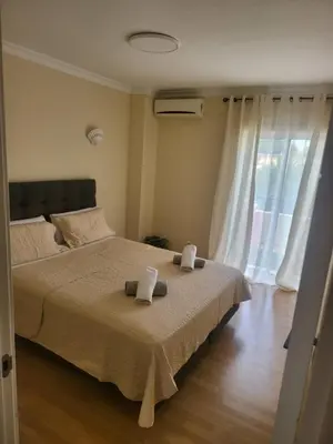 a bedroom with a bed with two towels on it at Flor do Campo in Albufeira