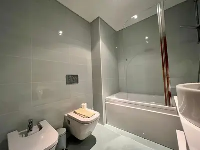a bathroom with a toilet and a shower and a sink at Villa Durban in Albufeira