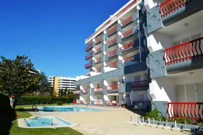 a building with a swimming pool in front of it at Tivoli AP Casino Vilamoura in Vilamoura