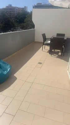 a balcony with chairs and a table on a roof at Tivoli AP Casino Vilamoura in Vilamoura