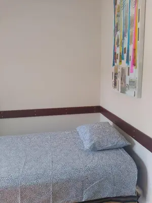a bed with two pillows on it in a room at Melaya Private Rooms in Faro