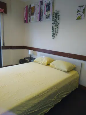 a bed with two pillows on it in a room at Melaya Private Rooms in Faro