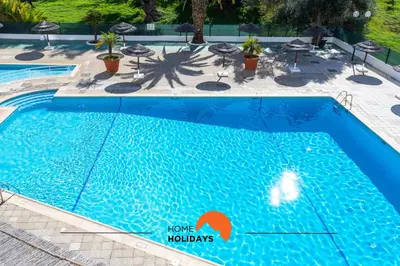 a man is playing golf on a golf course at #189 Montechoro Flat by Home Holidays in Albufeira