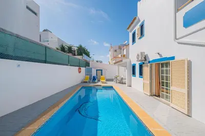 a swimming pool in the middle of a house at Villa Nina in Albufeira
