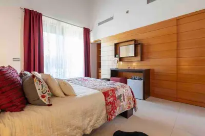 a bedroom with a large bed and a fireplace at Vale do Lobo Algarve,Exclusive Private Pool Villa in Vale do Lobo