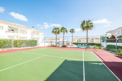 an image of a tennis court with palm trees at Sweet Home Arrifes in Albufeira