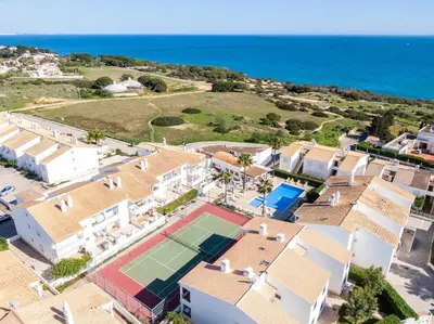 an aerial view of a house with a tennis court at Sweet Home Arrifes in Albufeira