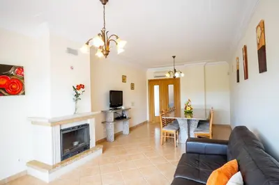 a living room with a couch and a fireplace at Thiago Holidays Apartment in Albufeira