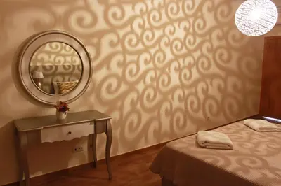 a bedroom with a mirror and a bed and a table at Achard Marina Apartment in Albufeira
