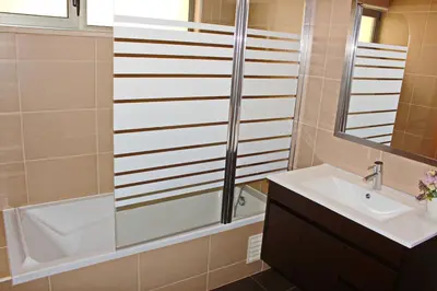 a bathroom with a tub and a sink and a bath tub at Achard Marina Apartment in Albufeira