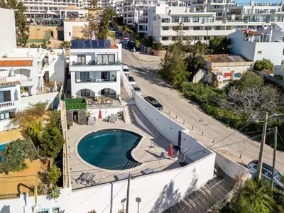 an aerial view of a building with a swimming pool at Malpique heated pool & Jacuzzi Guest House in Albufeira