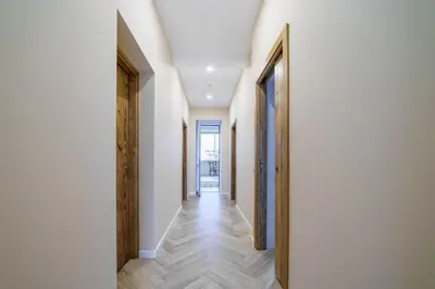 a hallway with white walls and wooden floors at Atlantic Bliss in Albufeira