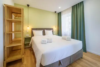 a bedroom with a large bed with two laptops on it at Atlantic Bliss in Albufeira