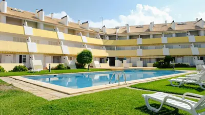 a swimming pool in front of a large building at Carpe Diem Vilamoura By Dualhotels in Vilamoura
