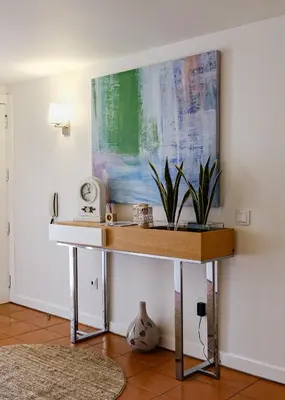 a desk in a room with a painting on the wall at Carpe Diem Vilamoura By Dualhotels in Vilamoura