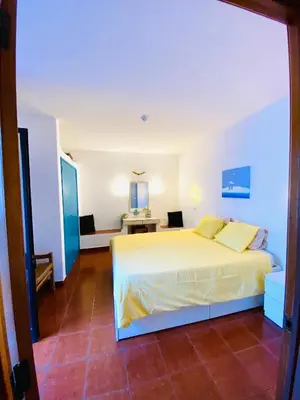 a bedroom with a large white bed in a room at Casa da Oura in Albufeira