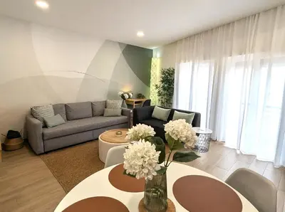 a living room with a couch and a table at Carmo House in Faro