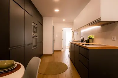a kitchen with a sink and a counter top at Carmo House in Faro