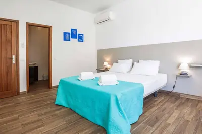 a bedroom with a bed with a blue table at Villa Namora in Albufeira