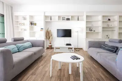 a living room with two couches and a table at Villa Namora in Albufeira