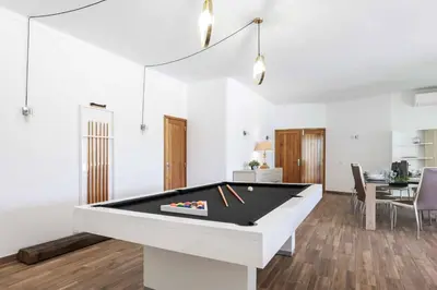 a living room with a pool table in it at Villa Namora in Albufeira