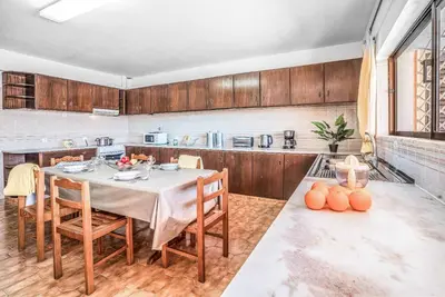 a kitchen with a table and chairs in a room at Casa Pluma in Albufeira